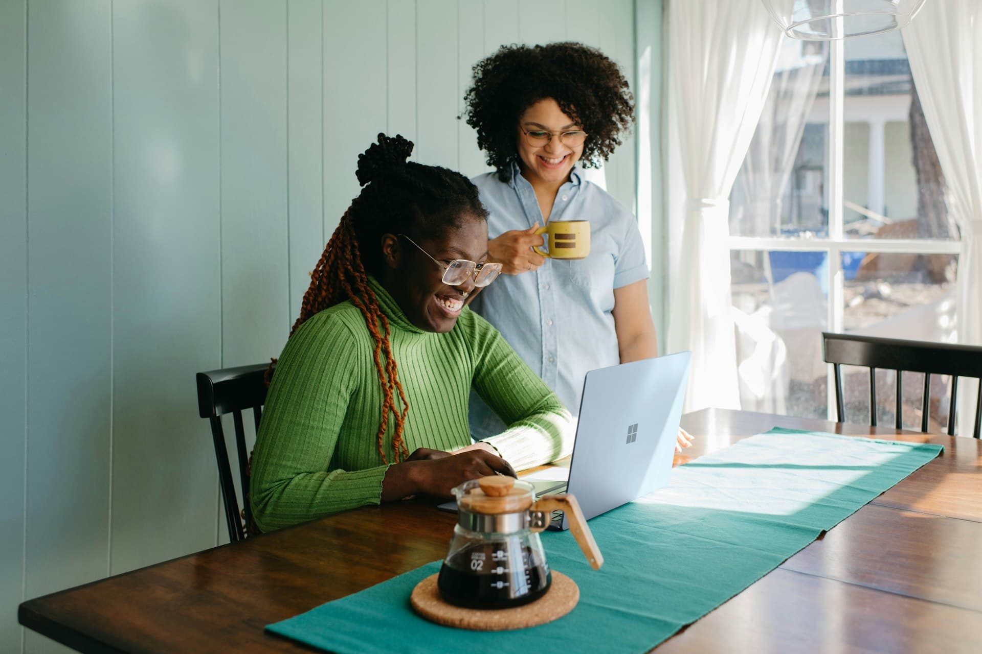 Two people reviewing their finances together at a kitchen table